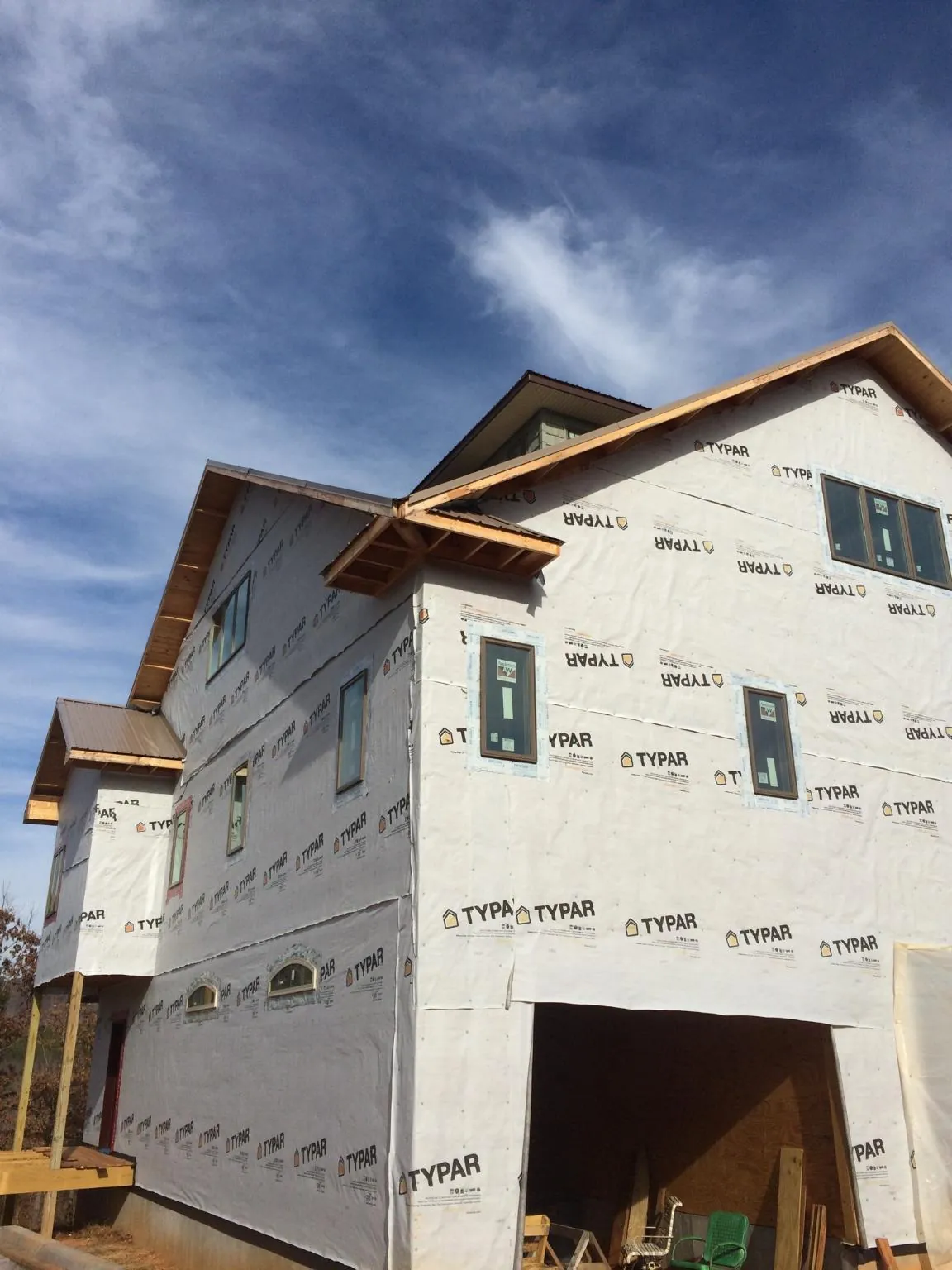 Stick built house wrapped in Typar with new roof framing and dormers in Northport